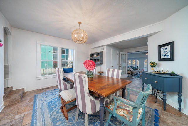 301 Kleinshore # 8, Hot Springs, AR 71913 - dining area featuring stone finish floors, a chandelier, and baseboards