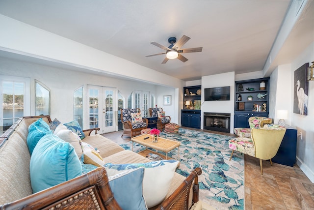 living room with ceiling fan and french doors