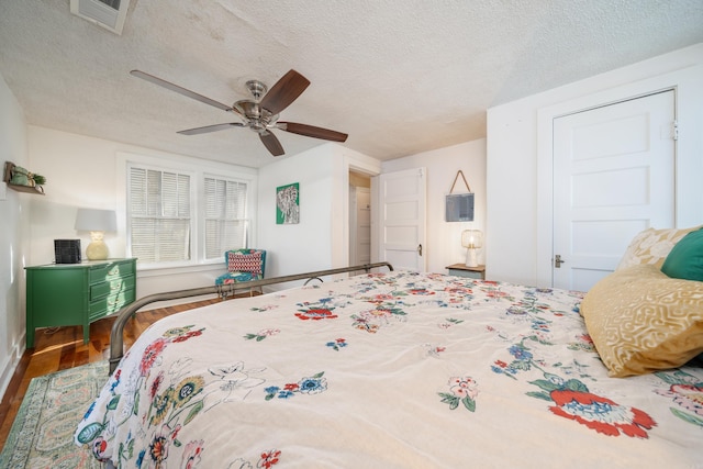 bedroom featuring ceiling fan, a textured ceiling, and hardwood / wood-style floors