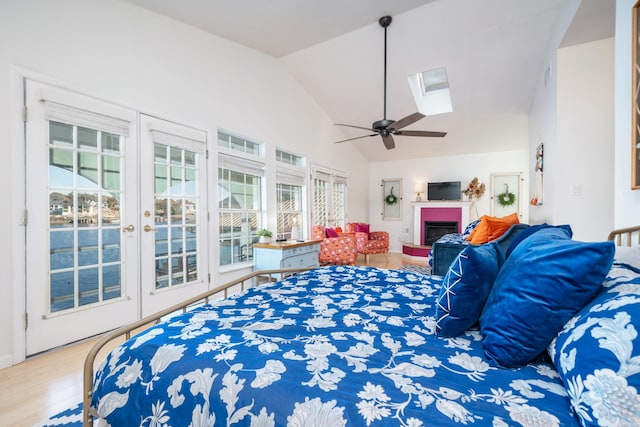 301 Kleinshore # 8, Hot Springs, AR 71913 - bedroom featuring access to exterior, wood finished floors, a skylight, a fireplace, and ceiling fan