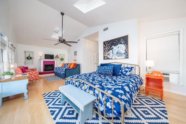 301 Kleinshore # 8, Hot Springs, AR 71913 - bedroom featuring a skylight, wood finished floors, vaulted ceiling, cooling unit, and a fireplace