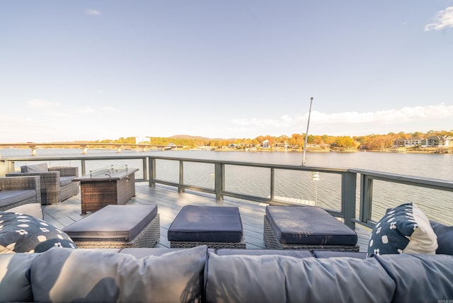 wooden terrace with an outdoor hangout area and a water view