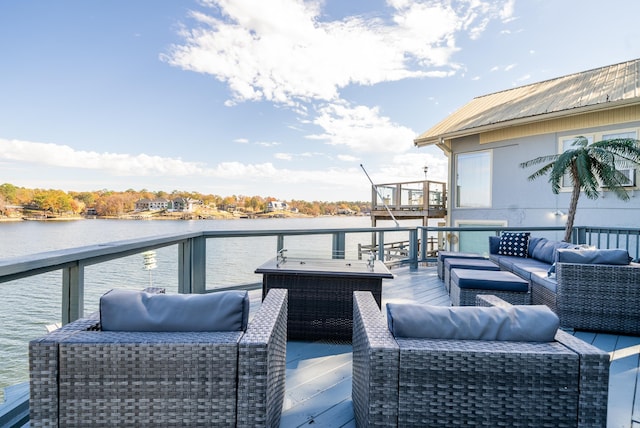 wooden terrace featuring a water view and an outdoor hangout area