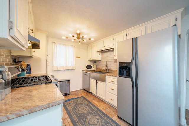 301 Kleinshore # 8, Hot Springs, AR 71913 - kitchen with appliances with stainless steel finishes, a sink, tasteful backsplash, light countertops, and under cabinet range hood
