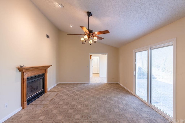 unfurnished living room with a textured ceiling, lofted ceiling, light carpet, and ceiling fan