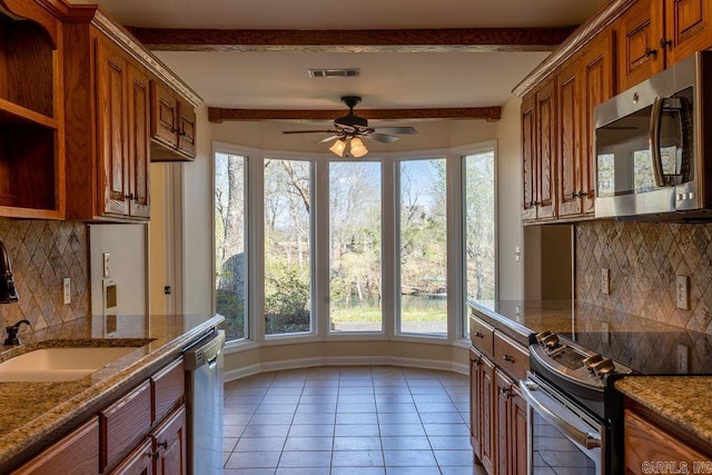 kitchen featuring beamed ceiling, decorative backsplash, stainless steel appliances, light tile patterned floors, and ceiling fan