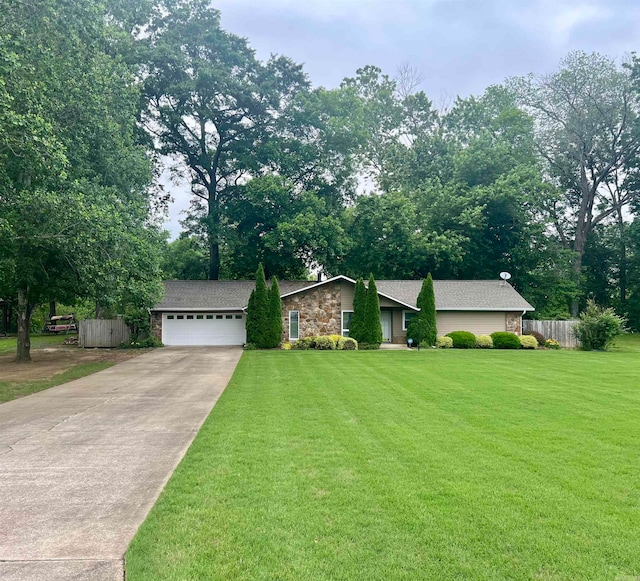 ranch-style home with a garage and a front lawn