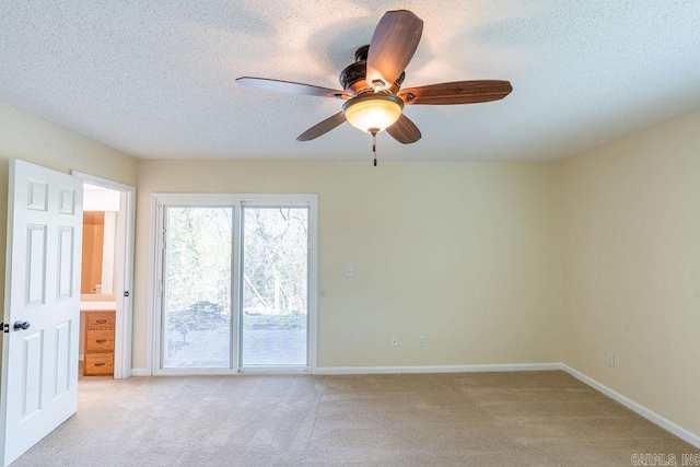 carpeted empty room with ceiling fan and a textured ceiling