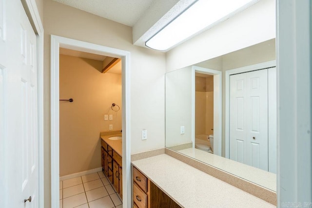 bathroom featuring vanity, toilet, and tile patterned floors