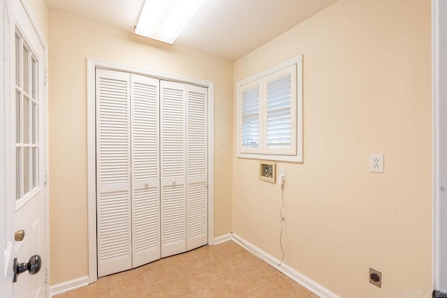 unfurnished bedroom featuring light tile patterned flooring and a closet