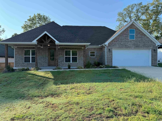 view of front of house featuring a garage and a front lawn