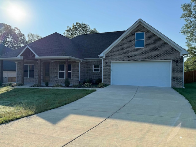 view of front of home featuring a garage and a front yard