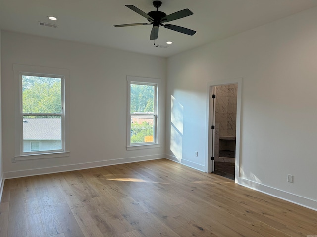 unfurnished room featuring ceiling fan, light hardwood / wood-style flooring, and plenty of natural light