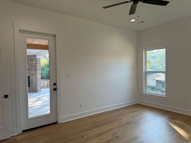 interior space featuring light wood-type flooring, ceiling fan, and a wealth of natural light