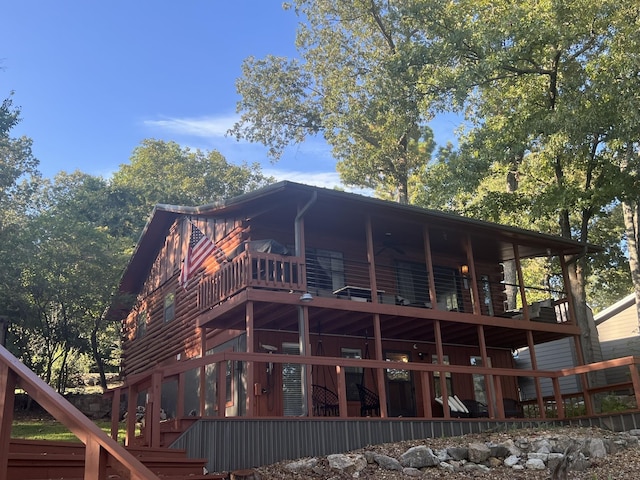 back of house featuring stairway and a wooden deck