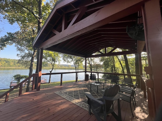 wooden terrace featuring a water view