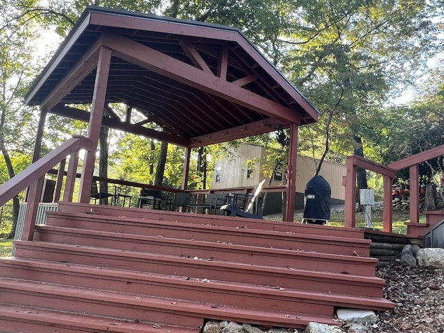 wooden terrace featuring a gazebo