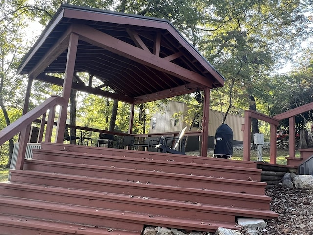 wooden terrace featuring a gazebo