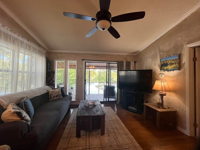 living room with ornamental molding, vaulted ceiling, ceiling fan, and dark hardwood / wood-style floors