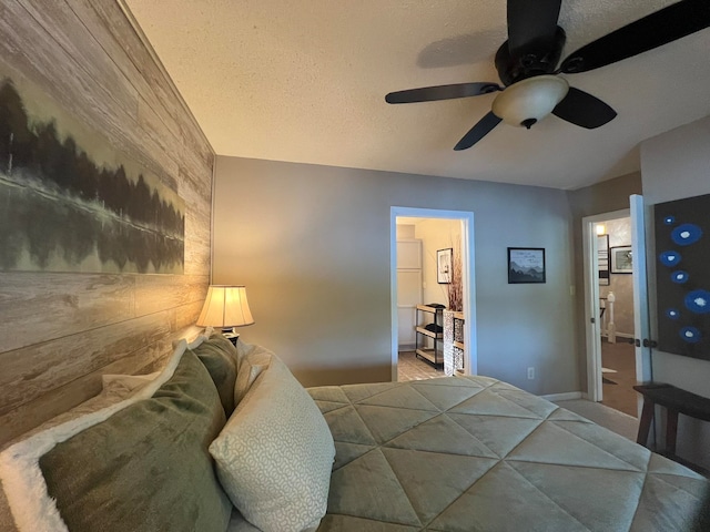 bedroom featuring ceiling fan, a textured ceiling, and connected bathroom