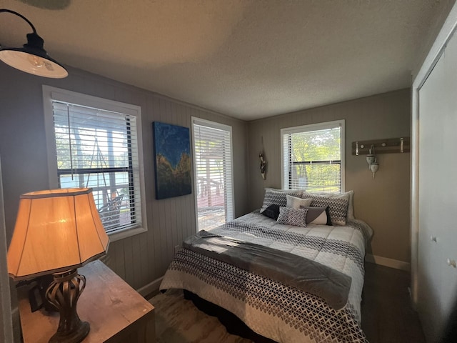 bedroom featuring baseboards, a closet, and a textured ceiling