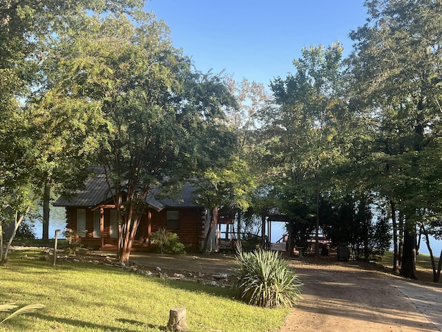 exterior space featuring covered porch, a front yard, and concrete driveway