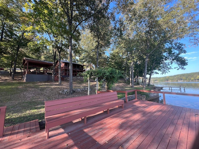 wooden terrace with a dock and a water view