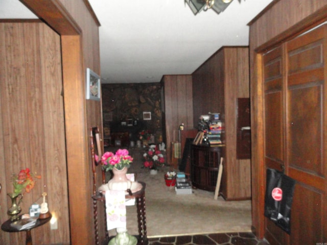 interior space featuring wood walls and carpet floors