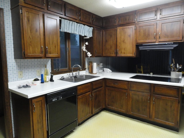 kitchen featuring dark brown cabinets, sink, decorative backsplash, and black appliances