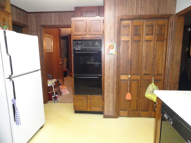 kitchen featuring white refrigerator, wood walls, stainless steel dishwasher, black double oven, and light colored carpet