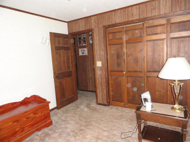 office space featuring light carpet, crown molding, and wood walls