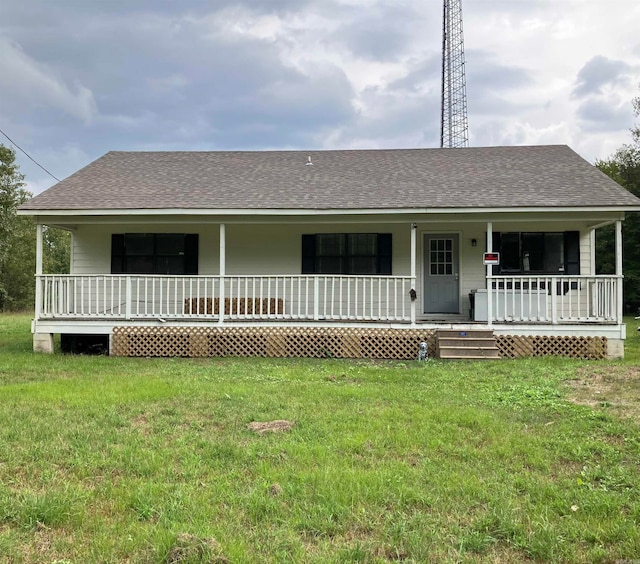 ranch-style house featuring covered porch and a front yard