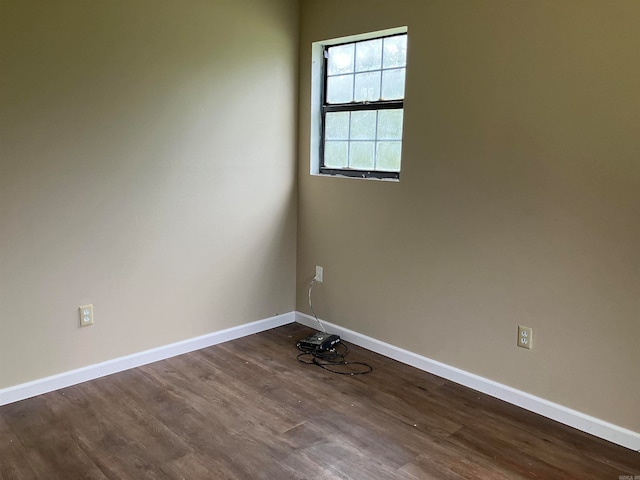 spare room with dark hardwood / wood-style floors