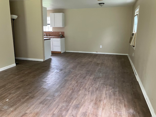 unfurnished living room featuring dark wood-type flooring