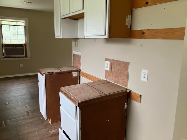 kitchen featuring tile counters, dark hardwood / wood-style flooring, and cooling unit