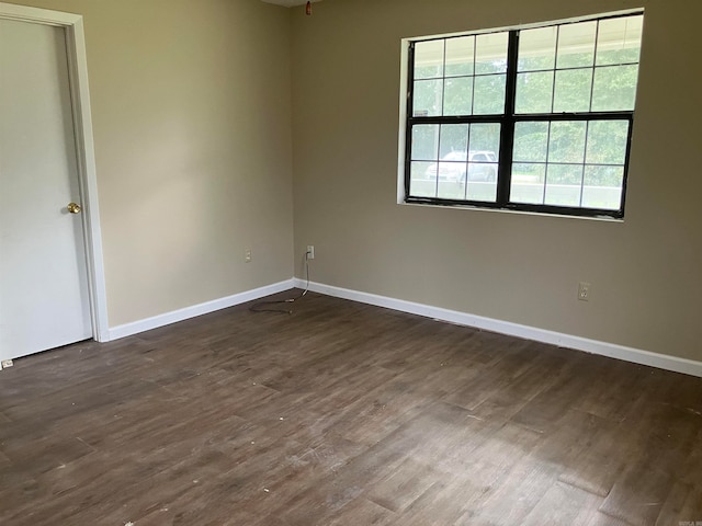 empty room with dark hardwood / wood-style floors