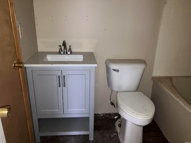 bathroom featuring a bath, vanity, and toilet