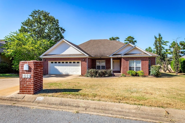 view of front of house with a front yard and a garage