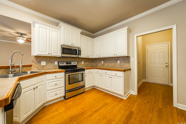 kitchen featuring light hardwood / wood-style flooring, stainless steel appliances, white cabinetry, and sink