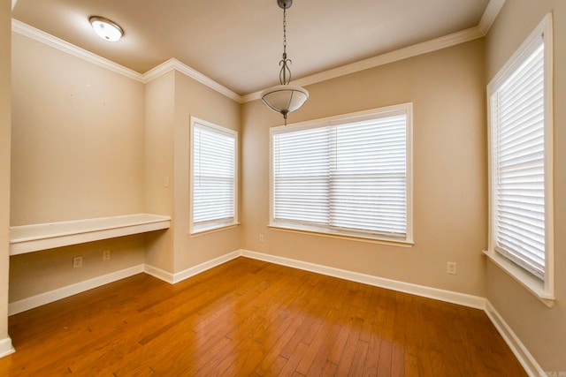 unfurnished room with hardwood / wood-style flooring and crown molding