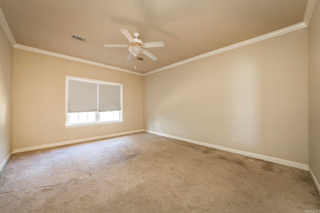 carpeted spare room with ceiling fan and crown molding