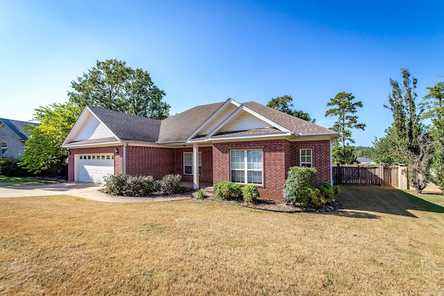 view of front of property with a front yard and a garage