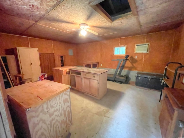 kitchen with a center island, ceiling fan, and light brown cabinets