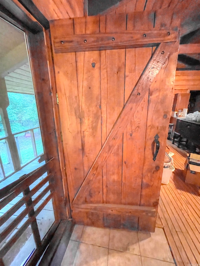 interior details featuring wood walls and tile patterned flooring