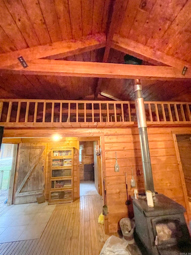 interior space featuring wooden ceiling, vaulted ceiling with beams, wooden walls, and hardwood / wood-style flooring