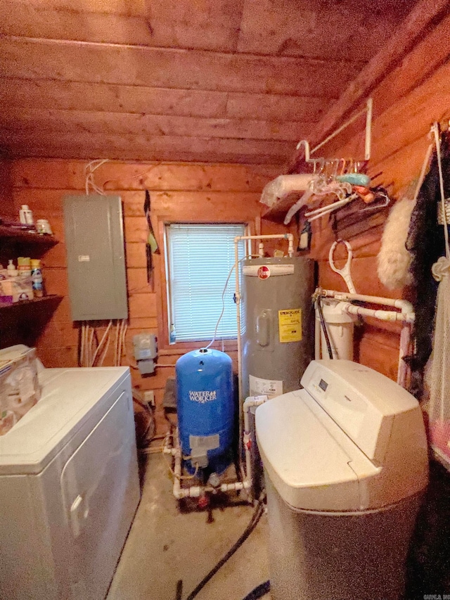 laundry area featuring water heater, washing machine and dryer, and electric panel