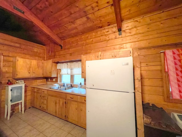 kitchen with wood walls, white refrigerator, and beamed ceiling