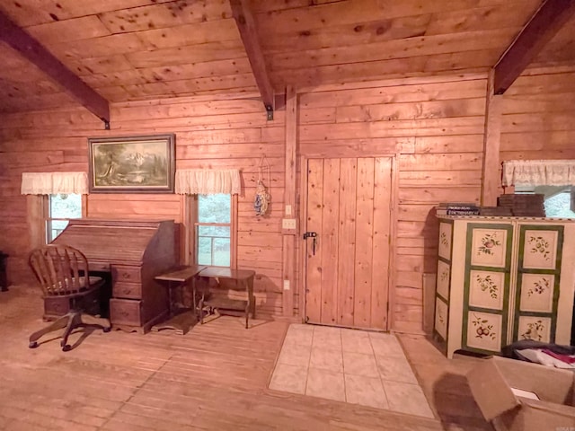 living area with wooden walls, wood ceiling, lofted ceiling with beams, and light hardwood / wood-style floors