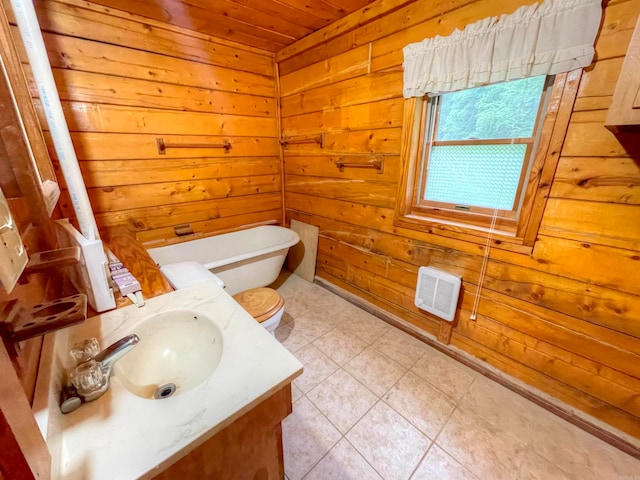 bathroom with tile patterned flooring, wood walls, wooden ceiling, vanity, and toilet