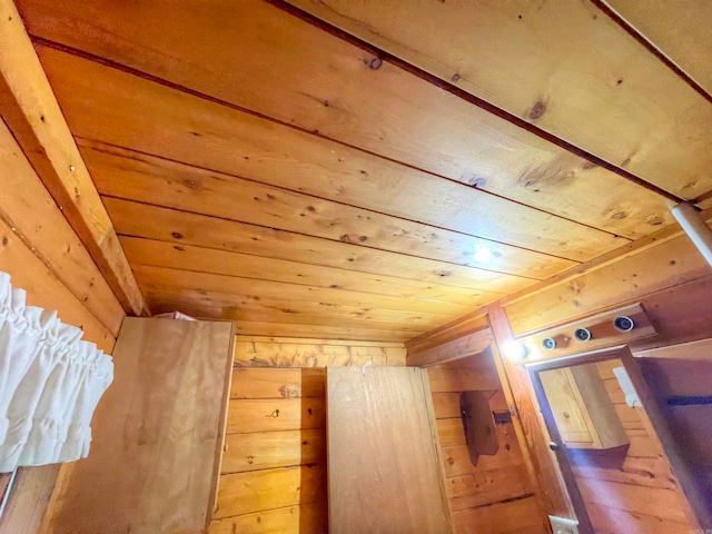 additional living space with wooden walls and wood ceiling